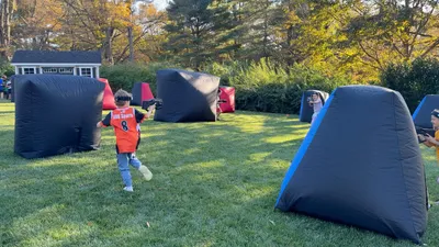 Kids playing outdoor laser tag at a backyard party in West Chester, PA
