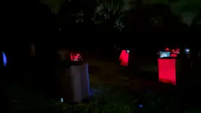 Glowing inflatable laser tag arena set up for a backyard 14th birthday party at night