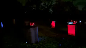 Glowing inflatable laser tag arena set up for a backyard 14th birthday party at night