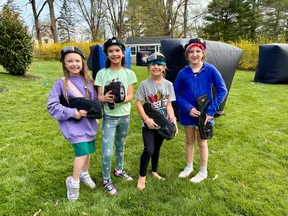 Four girls in laser tag headbands ready to play at an 8 year old's backyard birthday party in West Chester, PA