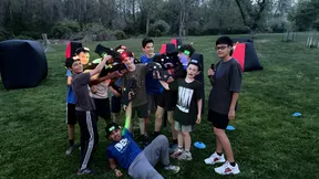Group of teens posing with laser taggers and headbands at a 14th birthday party hosted by Laser Tag Anywhere
