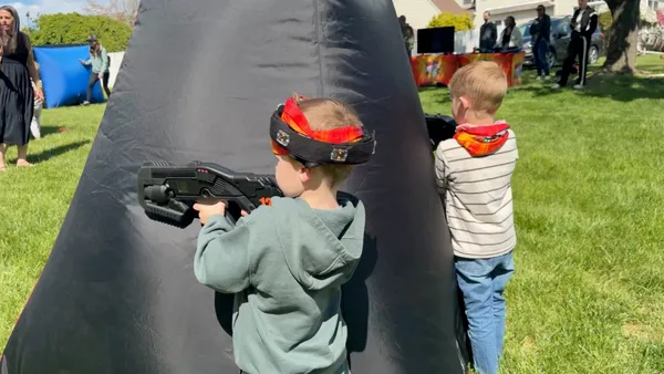 Preschoolers teaming up behind an inflatable bunker — Laser Tag Anywhere is built for all ages, even the youngest players