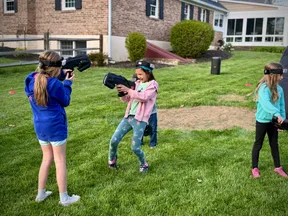 Three girls aiming laser taggers during an active 8 year old's birthday party in West Chester, PA