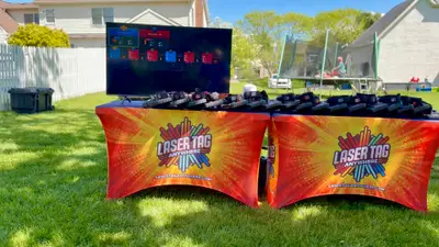 Mobile laser tag setup with pro-grade taggers and live game scoreboard ready in a Glen Mills, PA backyard