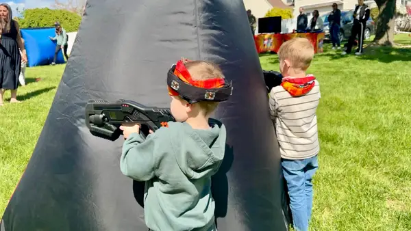 Preschoolers teaming up behind an inflatable bunker — Laser Tag Anywhere is built for all ages, even the youngest players