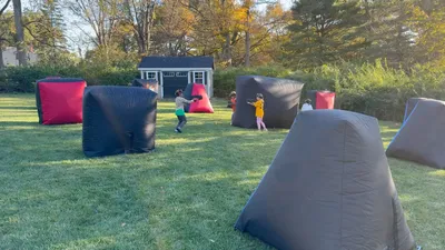 Group of kids playing a laser tag game outdoors in Chester County, PA
